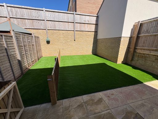 New artificial grass lawn in a fenced garden in Weston-Super-Mare.
