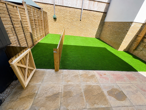 New artificial grass lawn in a fenced garden in Weston-Super-Mare.