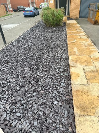 Decorative gravel area with natural stone edging in Weston-Super-Mare.