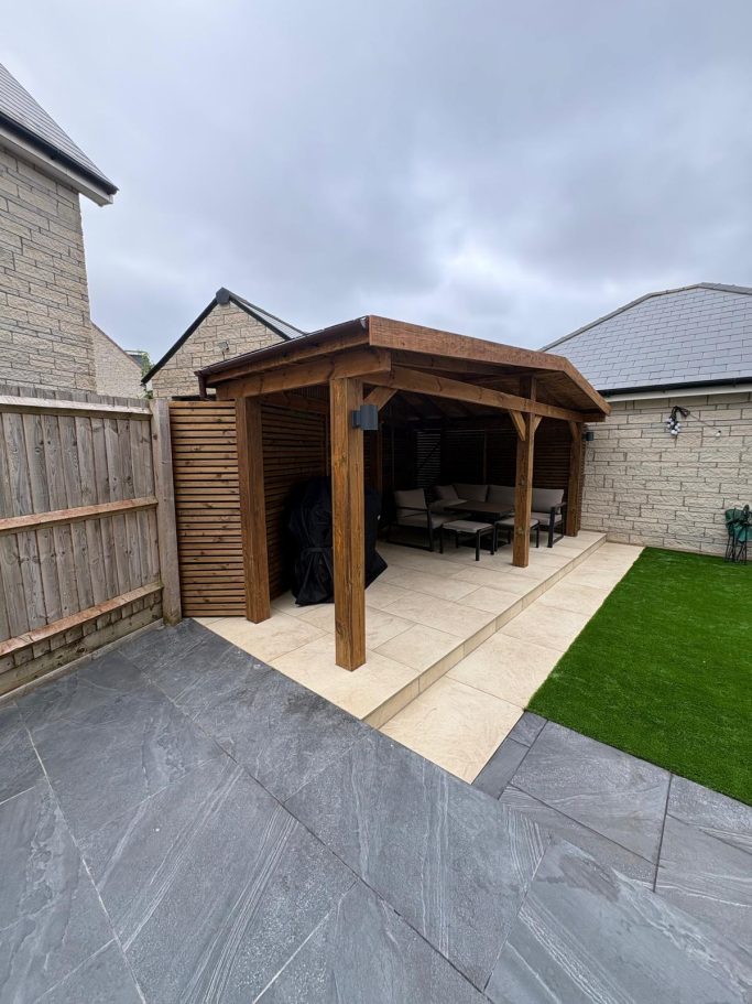 Timber Pergola and Garden Transformation in Weston-Super-Mare Bespoke timber pergola with a covered seating area, porcelain patio and artificial grass in Weston-Super-Mare.