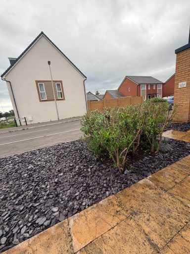Trees and bushes cut back with decorative slate added in Weston-Super-Mare.