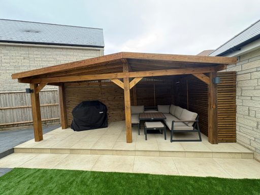 Bespoke timber pergola with a covered seating area, porcelain patio and artificial grass in Weston-Super-Mare.