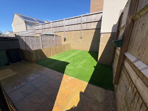 New artificial grass lawn in a fenced garden in Weston-Super-Mare.