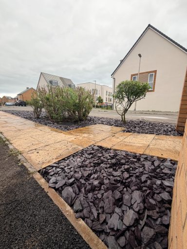 Trees and bushes cut back with decorative slate added in Weston-Super-Mare.
