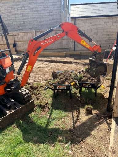 Mini digger carrying out garden excavation work in Weston-Super-Mare.