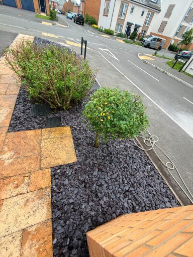 Trees and bushes cut back with decorative slate added in Weston-Super-Mare.